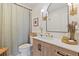 Updated bathroom featuring a tiled shower with a curtain, modern vanity, and decorative fixtures at 3641 Longmeadow # 33, Sarasota, FL 34235