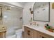 Modern bathroom features a glass enclosed shower, updated vanity, and a large mirror with contemporary lighting at 3641 Longmeadow # 33, Sarasota, FL 34235