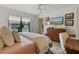Bright bedroom featuring a ceiling fan, wooden dresser, and a large window providing lots of natural light at 3641 Longmeadow # 33, Sarasota, FL 34235