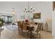 Inviting dining room with hardwood floors, elegant chandelier, and access to the living room, perfect for entertaining guests at 3641 Longmeadow # 33, Sarasota, FL 34235