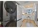 Modern kitchen with stainless steel appliances and a combination washer/dryer for convenience at 3641 Longmeadow # 33, Sarasota, FL 34235