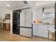 Modern kitchen with stainless steel appliances, white cabinets, and a combination washer/dryer for convenience at 3641 Longmeadow # 33, Sarasota, FL 34235