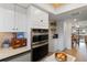 Modern kitchen with stainless steel appliances, white cabinets, and open layout, perfect for cooking and entertaining at 3641 Longmeadow # 33, Sarasota, FL 34235
