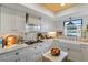 Bright kitchen featuring white cabinets, farmhouse sink, and modern appliances, creating a charming and functional space at 3641 Longmeadow # 33, Sarasota, FL 34235