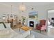 Spacious living room featuring a fireplace, hardwood floors, and elegant lighting, creating a warm and inviting atmosphere at 3641 Longmeadow # 33, Sarasota, FL 34235