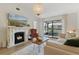 Bright living room with a fireplace, hardwood floors, and sliding doors leading to an outdoor patio space at 3641 Longmeadow # 33, Sarasota, FL 34235