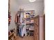 Well-organized walk-in closet with shelves and hanging space, adjacent to a wooden dresser for extra storage at 3641 Longmeadow # 33, Sarasota, FL 34235