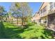 Scenic view of lush backyard with mature trees and a pond at 3691 Parkridge Cir # 201, Sarasota, FL 34243
