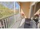 Screened balcony with seating and a grill overlooks lush greenery at 3691 Parkridge Cir # 201, Sarasota, FL 34243