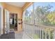 Screened balcony with seating and a view of lush trees at 3691 Parkridge Cir # 201, Sarasota, FL 34243