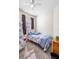 Small bedroom with floral bedding, window, curtains, and soft carpet at 3691 Parkridge Cir # 201, Sarasota, FL 34243