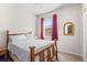 Bedroom with wood frame bed, soft carpet, window, and rattan mirror at 3691 Parkridge Cir # 201, Sarasota, FL 34243