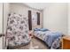 Small bedroom with floral bedding, window, curtains, and soft carpet at 3691 Parkridge Cir # 201, Sarasota, FL 34243
