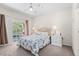 Bright bedroom with balcony access, ceiling fan, and light neutral paint at 3691 Parkridge Cir # 201, Sarasota, FL 34243