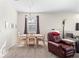 Inviting dining area with natural light, carpet flooring, and a view to the living room at 3691 Parkridge Cir # 201, Sarasota, FL 34243
