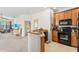 Efficient kitchen features wooden cabinetry, black appliances, granite countertops, and is open to the living area at 3691 Parkridge Cir # 201, Sarasota, FL 34243