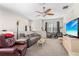 Comfortable living room featuring neutral carpeting, plenty of seating, and a ceiling fan at 3691 Parkridge Cir # 201, Sarasota, FL 34243
