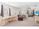 Comfortable living room featuring neutral carpeting, plenty of seating, and natural light from the windows at 3691 Parkridge Cir # 201, Sarasota, FL 34243