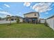 Manicured backyard with green grass, palm tree, and an enclosed lanai at 3818 Willow Walk Dr, Palmetto, FL 34221