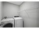 A well-lit laundry room with modern washer and dryer, and ample shelving at 3818 Willow Walk Dr, Palmetto, FL 34221