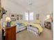 Bedroom featuring two twin beds, neutral carpet and bright lighting at 4123 Cascade Falls Dr, Sarasota, FL 34243
