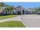 Elegant clubhouse exterior featuring lush landscaping and manicured lawns at 4123 Cascade Falls Dr, Sarasota, FL 34243