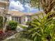 Charming beige home with a well-maintained lawn and a screened entryway for added privacy and curb appeal at 4123 Cascade Falls Dr, Sarasota, FL 34243