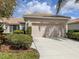 Charming home featuring a well-manicured lawn, beige exterior, and a convenient two-car garage at 4123 Cascade Falls Dr, Sarasota, FL 34243