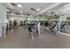 Community gym with modern equipment, mirrored wall, and natural light from windows at 4123 Cascade Falls Dr, Sarasota, FL 34243