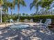 Relaxing hot tub area surrounded by lush greenery, lounge chairs, and a clear blue sky at 4123 Cascade Falls Dr, Sarasota, FL 34243