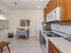 Bright eat-in kitchen featuring white appliances, wood cabinets, and a cozy breakfast area at 4123 Cascade Falls Dr, Sarasota, FL 34243