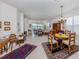 Spacious living and dining area featuring tile floors, stylish furnishings, and views of the serene lake at 4123 Cascade Falls Dr, Sarasota, FL 34243