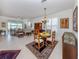 Spacious living and dining area featuring tile floors, stylish furnishings, and views of the serene lake at 4123 Cascade Falls Dr, Sarasota, FL 34243