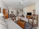 Open-concept living room with neutral colors and a ceiling fan, seamlessly connecting to the dining area at 4123 Cascade Falls Dr, Sarasota, FL 34243
