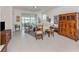 Bright living room with tile flooring, sliding glass doors to the lanai, and stylish Asian-inspired decor at 4123 Cascade Falls Dr, Sarasota, FL 34243