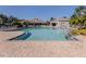 Large community pool with lap lane, surrounded by stamped concrete decking, lounge chairs, and umbrellas at 4123 Cascade Falls Dr, Sarasota, FL 34243