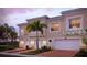 Beautiful two-story house with a two-car garage and palm trees at 4226 Frontier Ln # 103, Osprey, FL 34229