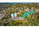 Community aerial view of pool and tennis courts near mature trees at 4260 Placida Rd # 25D, Englewood, FL 34224