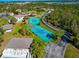 Aerial view of tennis courts surrounded by verdant trees and residences with a sliver of a pool visible at 4260 Placida Rd # 25D, Englewood, FL 34224