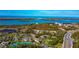 Condo community aerial view of beach, bay, and tennis court at 4260 Placida Rd # 25D, Englewood, FL 34224
