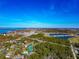 Expansive aerial view of residential area with community pools, tennis courts, and scenic waterways at 4260 Placida Rd # 25D, Englewood, FL 34224