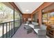 Spacious balcony with seating, wood paneled walls, and screened windows at 4260 Placida Rd # 25D, Englewood, FL 34224