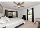 Large bedroom with ceiling fan, natural light, and a sliding glass door leading to a balcony at 4260 Placida Rd # 25D, Englewood, FL 34224
