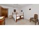 Bedroom featuring a queen bed with a ceiling fan, with white walls and light carpet at 4260 Placida Rd # 25D, Englewood, FL 34224