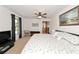 Bright bedroom featuring a ceiling fan, with an ensuite bathroom and carpeted flooring at 4260 Placida Rd # 25D, Englewood, FL 34224
