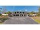 Two-story condominium building with covered parking and exterior stairs at 4260 Placida Rd # 25D, Englewood, FL 34224