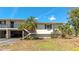 Charming condo with tropical landscaping, carport, and private access stairs at 4260 Placida Rd # 25D, Englewood, FL 34224