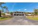 Two-story condominium building with covered parking and exterior stairs at 4260 Placida Rd # 25D, Englewood, FL 34224