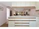 View of the kitchen countertop and drawers, leading into the open floor plan living and dining area at 4260 Placida Rd # 25D, Englewood, FL 34224