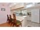 Cozy kitchen with white appliances, breakfast bar seating, and a bright, welcoming atmosphere at 4260 Placida Rd # 25D, Englewood, FL 34224